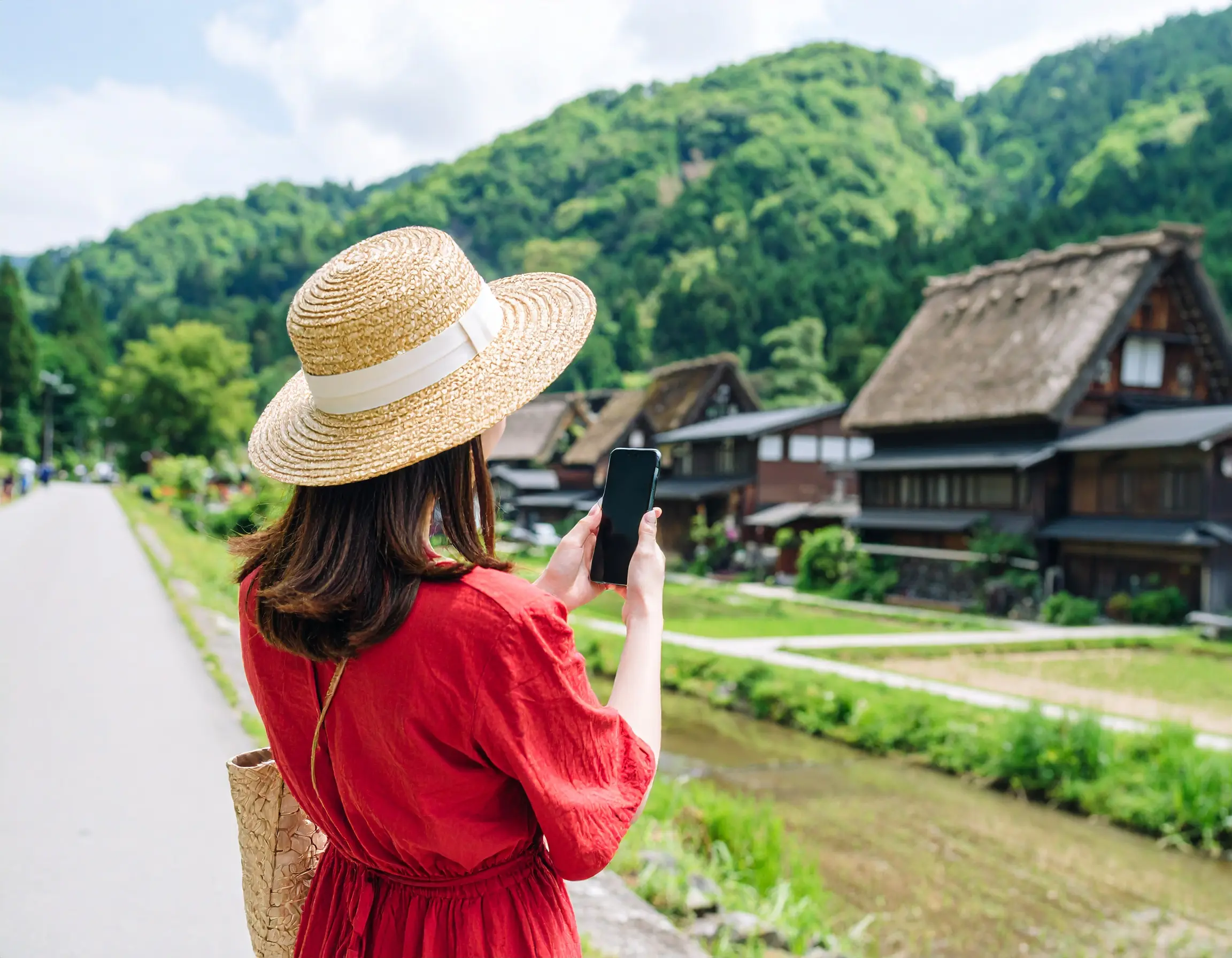 地方都市でスマホを構える女性。中小企業がMinifluサービスでAIマッチングしたミニインフルエンサーを活用したPRを行い、地域ビジネスの集客を増やし、地元を活性化するイメージ
